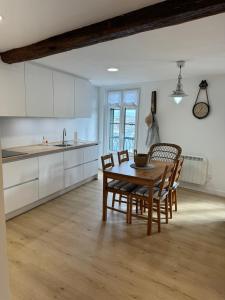 a kitchen with a wooden table and chairs at ISTUA - Etxie La Casa in Bermeo