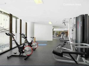 a gym with two bikes and tread machines at Axle x Apartment in Brisbane