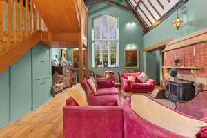 a living room with purple furniture and a fireplace at Country House with 7 bedrooms and 3 buildings in Market Rasen