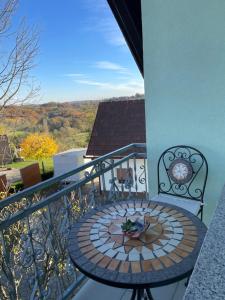 a table on a balcony with a view at Beautiful house surrounded by pure nature in Rogašovci