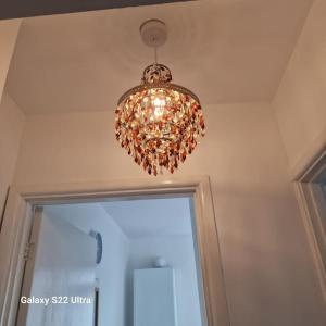 a chandelier hanging from the ceiling in a room at 4 Bed Park View House-Free Parking - Sleep 8 in Plymouth