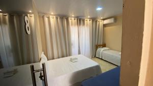 a hospital room with two beds and a window at Pousada Floripes in Morro de São Paulo