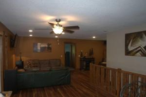 a living room with a couch and a ceiling fan at Cuyuna Lake Cabin Retreat in Ironton
