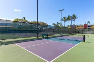 a tennis court with a bench on top of it at Papakea E206- Updated Papakea oceanview condo, all the amenities in Kahana
