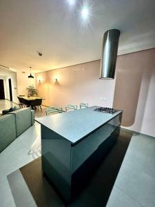 a kitchen with a counter and a table in a room at Stunning 2BR APT w/Pool&Garden in St Julian's