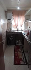 a small kitchen with a rug on the floor at Omar Apartments in Casablanca