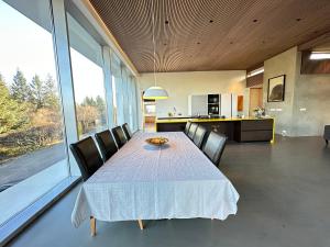 a dining room with a table and chairs at Villa by the lake Elliðavatn - Birta Rentals in Reykjavík