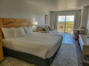 a bedroom with a large bed and a living room at Chautauqua Resort & Conference Center in Long Beach