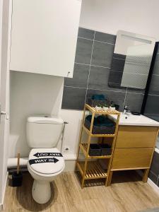 een badkamer met een toilet en een wastafel bij Cocoon citadin : Appartement 2 pièces au coeur d'Evry in Évry-les-Châteaux