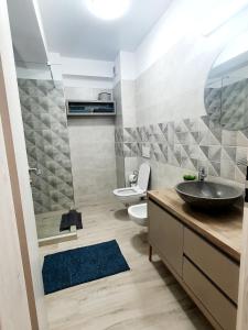 ein Bad mit einem Waschbecken und einem WC in der Unterkunft 'Just like home' Apartment - with Private Parking Place in Galaţi