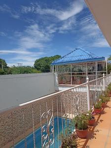 a balcony with a gazebo and potted plants at Hotel Orquídea Real in Valledupar