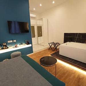 a living room with a bed and a tv on a wall at La Lepre Bovio in Naples