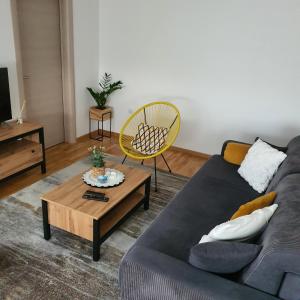 a living room with a couch and a coffee table at JR Lux apartman in Stara Pazova