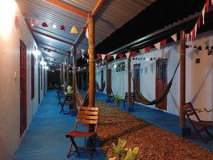 a porch with chairs and hammocks at night at Hotel campestre la Maria in Villavicencio