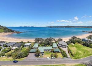 an aerial view of a resort with a beach at The Sands Motel in Tutukaka