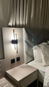 a cross on the side of a bed with a cross on it at جادا للشقق المخدومة Jada in Al Khobar +1 photo