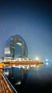 a large building in the middle of a body of water at A & F HOSTEL in Baku