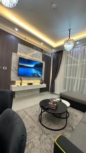 a living room with a couch and a table at Luxury 2 bedroom new brand in Ajman 