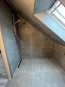 a bathroom with a shower with a tiled floor at Wohnung in Herford in Herford