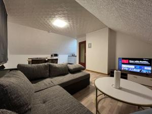 a living room with a couch and a table and a tv at Wohnung in Herford in Herford