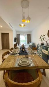 a dining room table with plates and wine glasses on it at Apartamento de 2 Dormitorios en Hard Rock Golf in Punta Cana