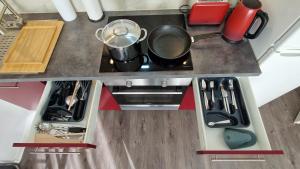 an overhead view of a kitchen with a stove at King Bed 4 people near Basel, Switzerland, Weil am Rhein, Loerrach, Germ'any, Near Airport in Saint-Louis