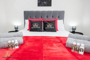 a bedroom with a bed with a red carpet at Hades Apartment - The Soul of Town in Southampton