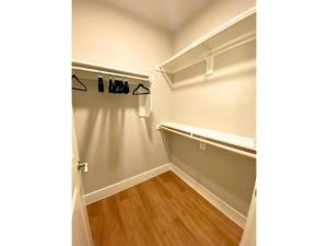 an empty walk in closet with a wooden floor at Ft Worth 1BR Luxury Retreat in Fort Worth
