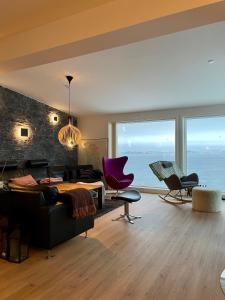 a living room with a view of the ocean at The White House in Nuuk