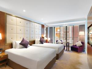 a hotel room with two beds and a balcony at Amora Hotel Jamison Sydney in Sydney