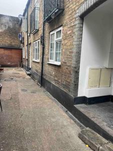 a brick building with a door on the side of it at Nice StudioFLAT in London in London