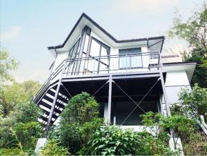 a white house with a balcony and trees at Chalet Itomic L - Lake view - in Hakone