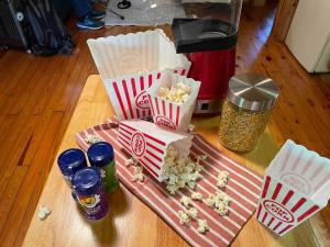 a table with popcorn popcorn and drinks on a table at Nantahala Resort cabin, POOL OPEN, horseback riding, game room, gym, restaurant on site in Bryson City
