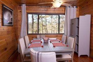 a dining room with a table and chairs and a window at Nantahala Resort cabin, POOL OPEN, horseback riding, game room, gym, restaurant on site in Bryson City