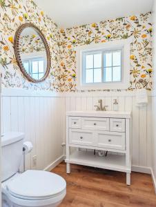 a bathroom with a white sink and a mirror at The Garden House of Downtown Manitou Springs in Manitou Springs