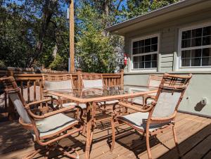 a wooden table and chairs on a deck at The Garden House of Downtown Manitou Springs in Manitou Springs