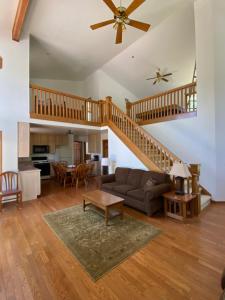 a living room with a staircase and a couch at Adventures @ Cottage on the Bend in Leota