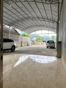 two cars are parked in a parking lot at Green Hotel Cao Bằng in Cao Bằng +24 photos