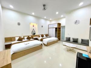 una camera d'albergo con due letti e una televisione di GREEN HOTEL a Cao Bằng