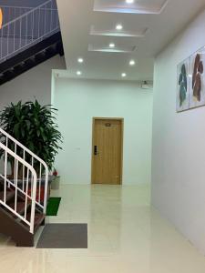 a hallway with a wooden door in a building at Green Hotel Cao Bằng in Cao Bằng