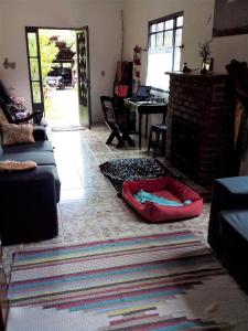 a living room with a couch and a fireplace at Casa SFX Centro in São José dos Campos +10 photos