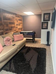 a living room with a couch and a pool table at Home Away in Conyers