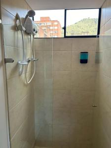 a shower with a shower head in a bathroom at Apartamento Bogotá con vista a Monserrate in Bogotá