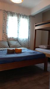 a bedroom with a bed and a window with blue sheets at La Kaz'ida in Cilaos