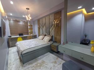 a bedroom with a bed and a desk in it at Designed 2 rooms in Dushanbe