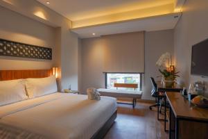 Ένα ή περισσότερα κρεβάτια σε δωμάτιο στο BATIQA Hotel Lampung