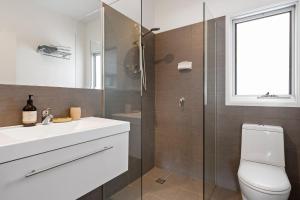 a bathroom with a toilet and a sink and a shower at Aaman & Cinta Luxury Villas in Byron Bay