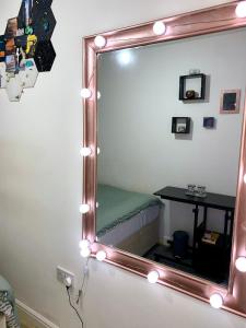 a mirror with lights and a table in a room at Private Room in shared Apartment Free Parking -20min to Manchester in Manchester