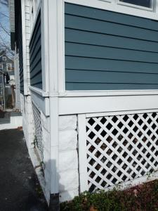 a house with a white fence on the side of it at "Cozy Basement Retreat Just 40 Minutes to NYC!" in Irvington