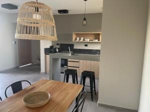a kitchen with a table and chairs and a dining room at La Morada Almafuerte in Almafuerte